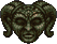 A creepy-looking green face with horns on the head with glowingread eyes.